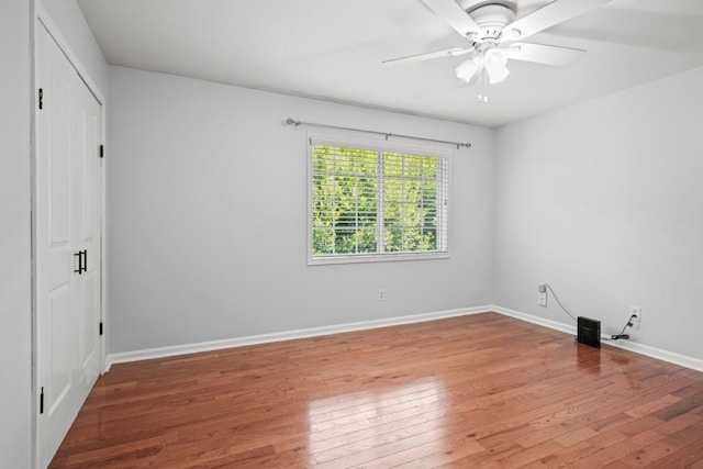 unfurnished bedroom with ceiling fan and wood-type flooring