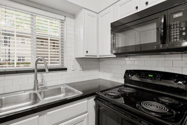 kitchen featuring sink, a healthy amount of sunlight, decorative backsplash, white cabinets, and black appliances