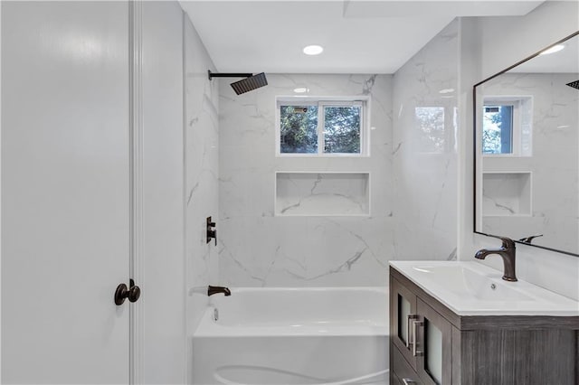 bathroom with a wealth of natural light, tub / shower combination, and vanity