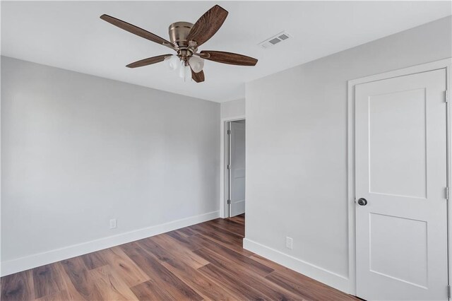 unfurnished bedroom with baseboards, visible vents, ceiling fan, and wood finished floors