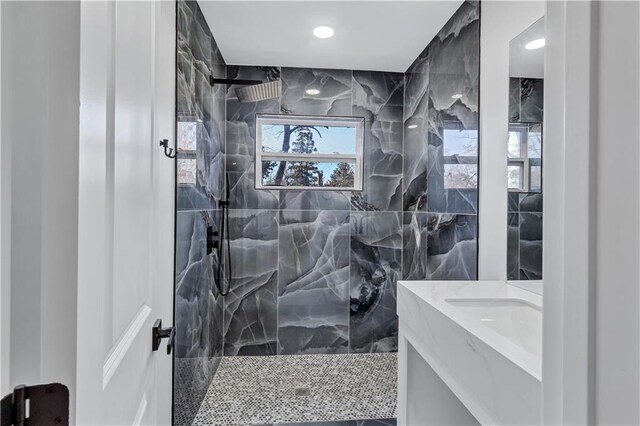 full bathroom with vanity and a walk in shower