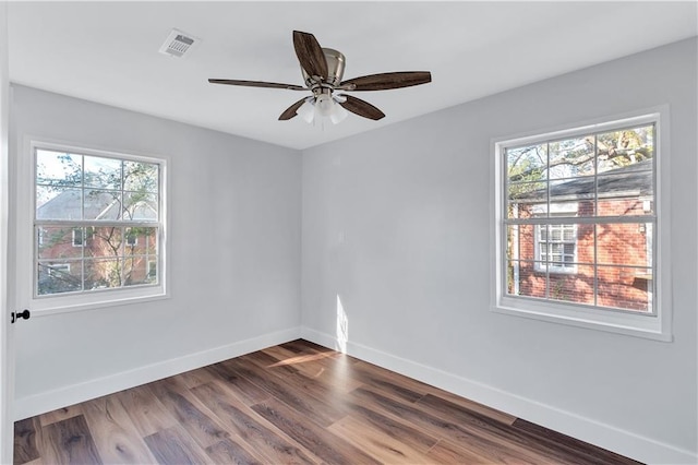 spare room with baseboards, visible vents, and a wealth of natural light