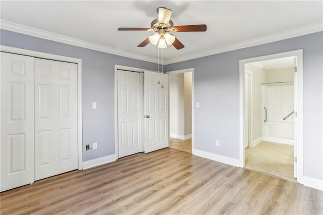 300 Johnson Ferry Rd NE Unit A811, Atlanta, GA 30328 - unfurnished bedroom with two closets, light wood-style flooring, crown molding, connected bathroom, and ceiling fan