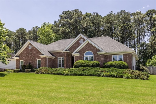 3845 Glen Ian Dr, Loganville, GA 30052 - view of front of house with brick siding, a front yard, and roof with shingles