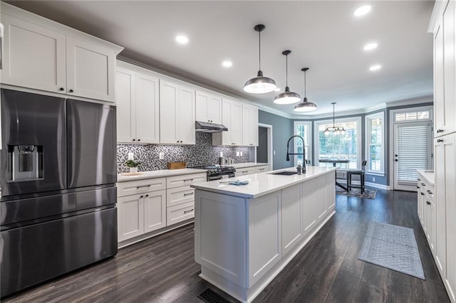 3845 Glen Ian Dr, Loganville, GA 30052 - kitchen with stainless steel appliances, under cabinet range hood, ornamental molding, recessed lighting, and a sink