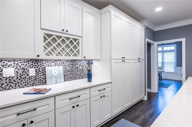 3845 Glen Ian Dr, Loganville, GA 30052 - kitchen featuring crown molding, white cabinetry, dark wood finished floors, backsplash, and light stone counters