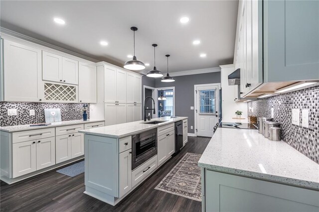 3845 Glen Ian Dr, Loganville, GA 30052 - kitchen featuring dishwashing machine, crown molding, a sink, white cabinetry, and backsplash