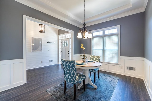3845 Glen Ian Dr, Loganville, GA 30052 - dining space with a wainscoted wall, a chandelier, dark wood-type flooring, a decorative wall, and a tray ceiling