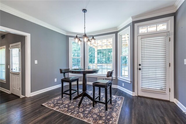 3845 Glen Ian Dr, Loganville, GA 30052 - dining area featuring baseboards, a chandelier, dark wood-style flooring, and crown molding