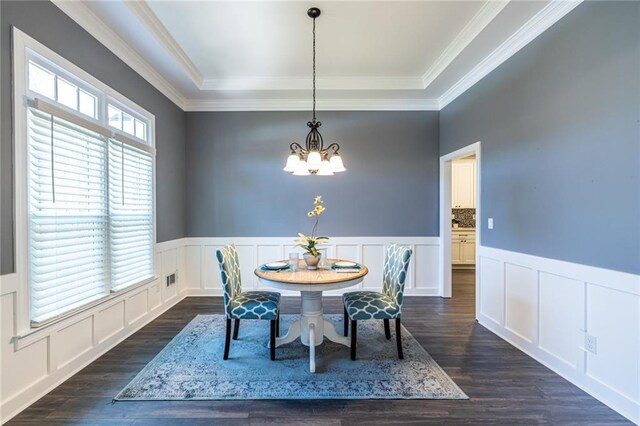 3845 Glen Ian Dr, Loganville, GA 30052 - dining space with a chandelier, wainscoting, dark wood finished floors, ornamental molding, and a decorative wall