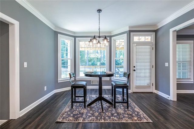 3845 Glen Ian Dr, Loganville, GA 30052 - dining space featuring baseboards, a chandelier, dark wood-style flooring, and crown molding
