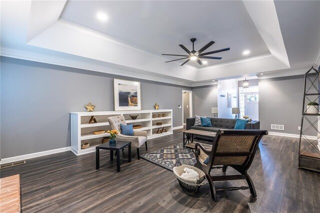 3845 Glen Ian Dr, Loganville, GA 30052 - living room with a raised ceiling, ceiling fan, baseboards, wood finished floors, and crown molding