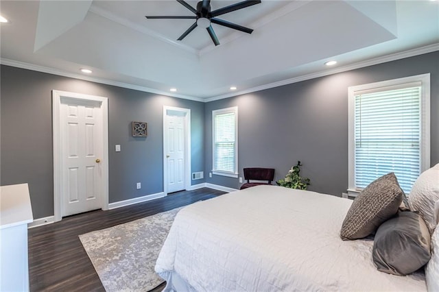 3845 Glen Ian Dr, Loganville, GA 30052 - bedroom with dark wood-type flooring, baseboards, recessed lighting, crown molding, and a tray ceiling