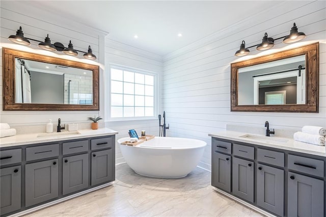 3845 Glen Ian Dr, Loganville, GA 30052 - full bathroom with ornamental molding, marble finish flooring, two vanities, a freestanding bath, and wooden walls