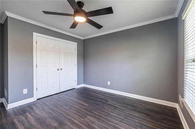 3845 Glen Ian Dr, Loganville, GA 30052 - unfurnished bedroom with baseboards, dark wood-style flooring, ornamental molding, a closet, and ceiling fan