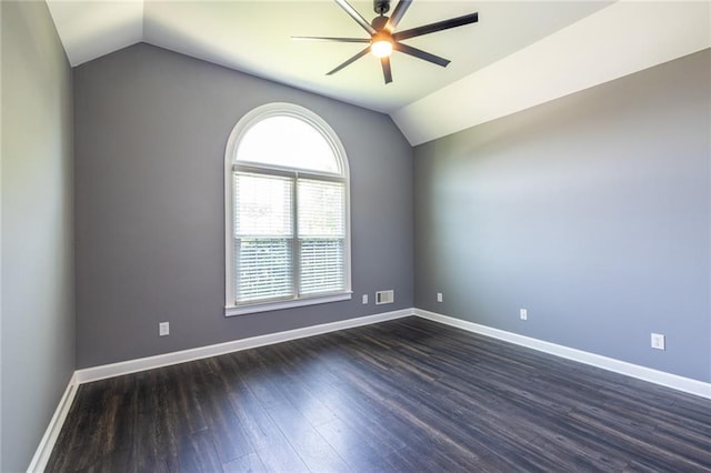 3845 Glen Ian Dr, Loganville, GA 30052 - spare room with lofted ceiling, ceiling fan, dark wood finished floors, and baseboards