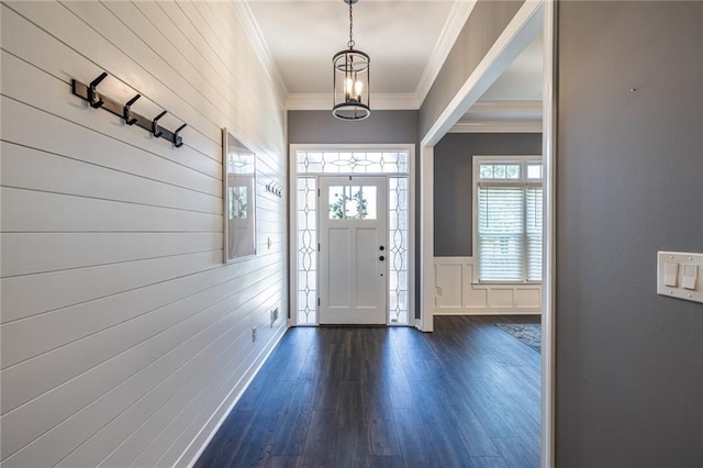 3845 Glen Ian Dr, Loganville, GA 30052 - entrance foyer with ornamental molding, dark wood-type flooring, a chandelier, a decorative wall, and a wainscoted wall