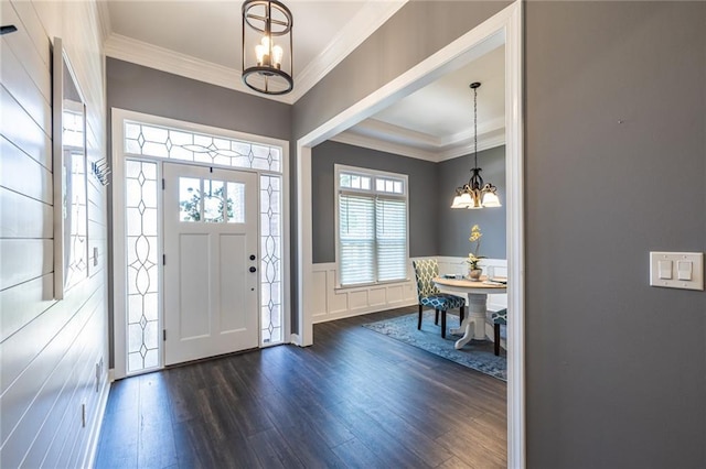 3845 Glen Ian Dr, Loganville, GA 30052 - entryway with a chandelier, dark wood-style floors, wainscoting, crown molding, and a decorative wall