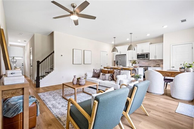 212 Starr Cir, Stockbridge, GA 30281 - living area featuring ceiling fan, stairway, light wood-style flooring, recessed lighting, and baseboards