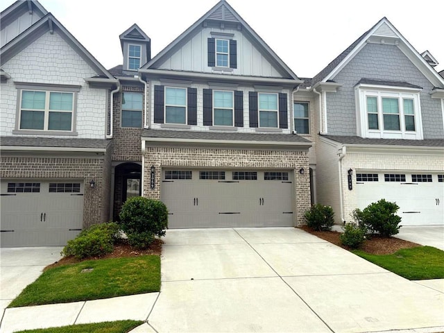2059 Lanier Harbor Pt, Buford, GA 30518 - view of front of home with driveway, a garage, brick siding, and board and batten siding