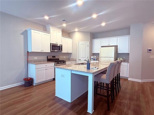 2059 Lanier Harbor Pt, Buford, GA 30518 - kitchen with stainless steel appliances, dark wood-style flooring, white cabinetry, and recessed lighting