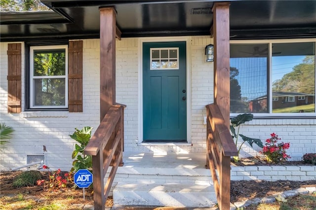 2358 Tilson Rd, Decatur, GA 30032 - doorway to property with covered porch, brick siding, and crawl space