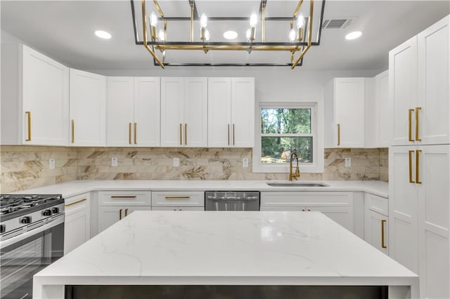 2358 Tilson Rd, Decatur, GA 30032 - kitchen featuring stainless steel appliances, tasteful backsplash, a chandelier, white cabinetry, and recessed lighting