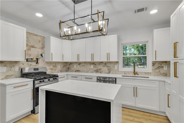 2358 Tilson Rd, Decatur, GA 30032 - kitchen with stainless steel appliances, backsplash, white cabinets, a chandelier, and recessed lighting