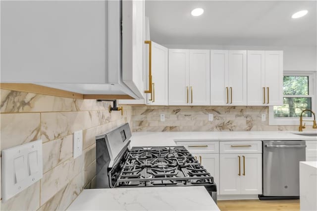 2358 Tilson Rd, Decatur, GA 30032 - kitchen with stainless steel appliances, white cabinetry, tasteful backsplash, light stone counters, and recessed lighting