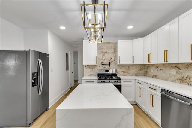 2358 Tilson Rd, Decatur, GA 30032 - kitchen featuring appliances with stainless steel finishes, light wood finished floors, tasteful backsplash, a center island, and recessed lighting