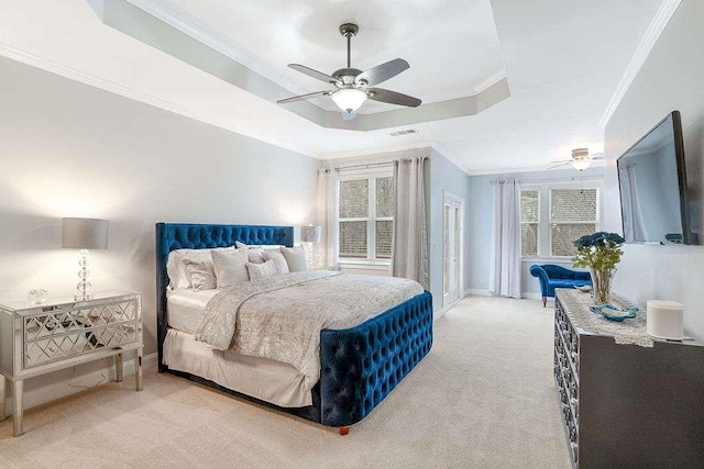 bedroom featuring ceiling fan, ornamental molding, a raised ceiling, and light colored carpet