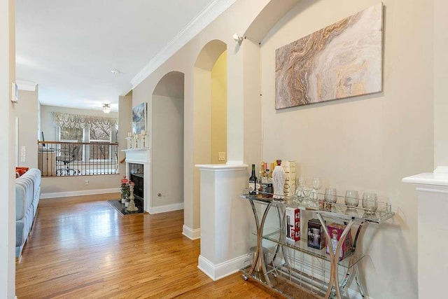 hallway featuring wood-type flooring and ornamental molding