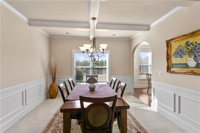 1307 Clarecastle Ln, Buford, GA 30519 - dining area featuring arched walkways, light colored carpet, a decorative wall, a chandelier, and beam ceiling