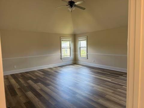 1307 Clarecastle Ln, Buford, GA 30519 - empty room with a ceiling fan, dark wood finished floors, baseboards, and lofted ceiling