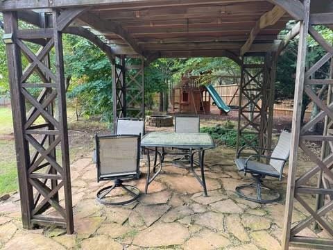 1307 Clarecastle Ln, Buford, GA 30519 - view of patio featuring a playground