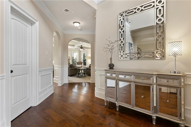 1307 Clarecastle Ln, Buford, GA 30519 - corridor featuring crown molding, arched walkways, dark wood-style flooring, a wainscoted wall, and a decorative wall