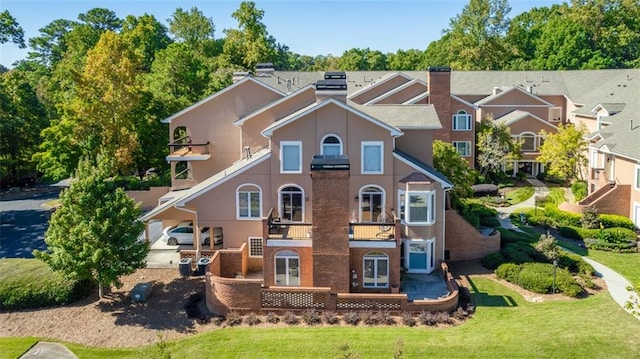 rear view of property featuring a yard