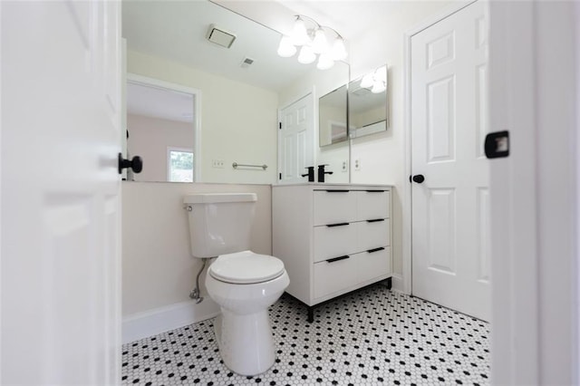 bathroom with tile patterned flooring, vanity, and toilet