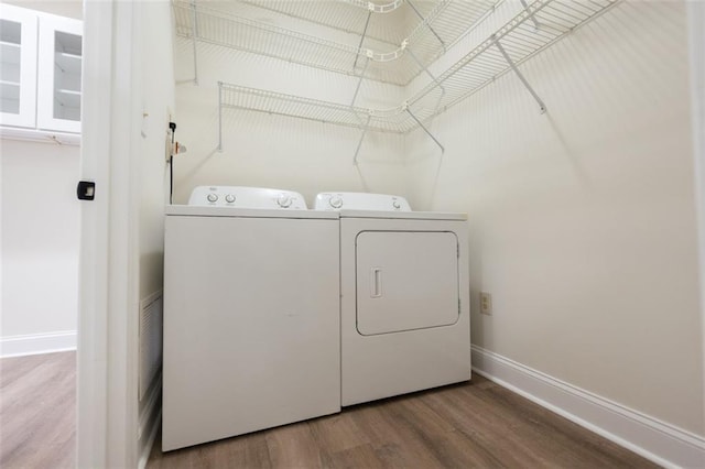 laundry area with hardwood / wood-style floors and washer and clothes dryer