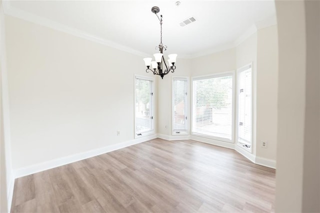 unfurnished room featuring a chandelier, light hardwood / wood-style flooring, and crown molding