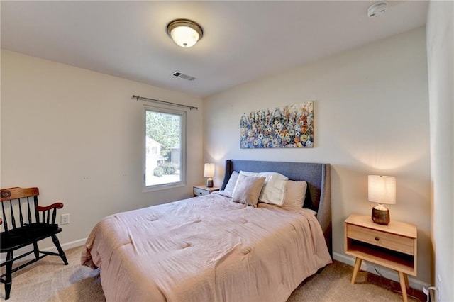 bedroom featuring baseboards, visible vents, and light colored carpet