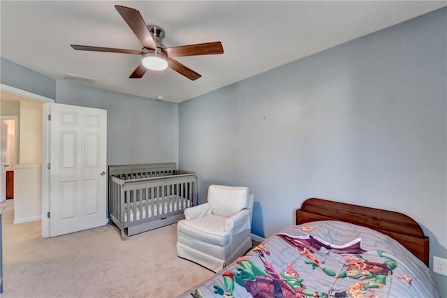 bedroom featuring a ceiling fan, light carpet, and visible vents