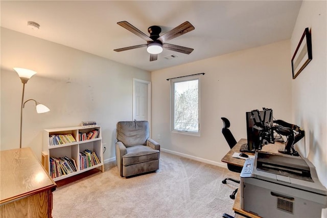 office space featuring light carpet, ceiling fan, visible vents, and baseboards