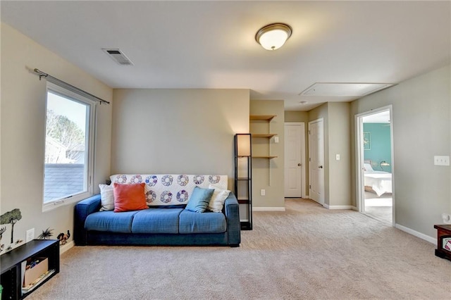 living area featuring light carpet, visible vents, and baseboards