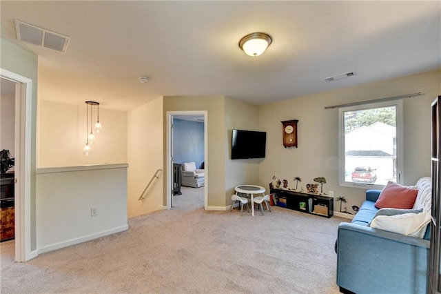 carpeted living room featuring visible vents and baseboards