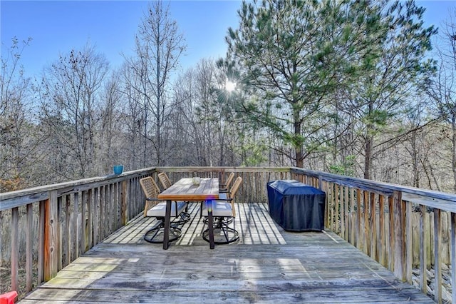 wooden terrace featuring outdoor dining space