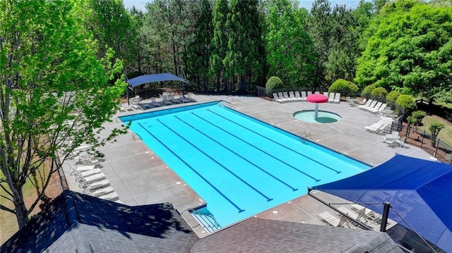 pool featuring a patio area, fence, and a community hot tub