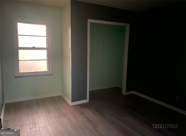 empty room featuring baseboards and wood finished floors