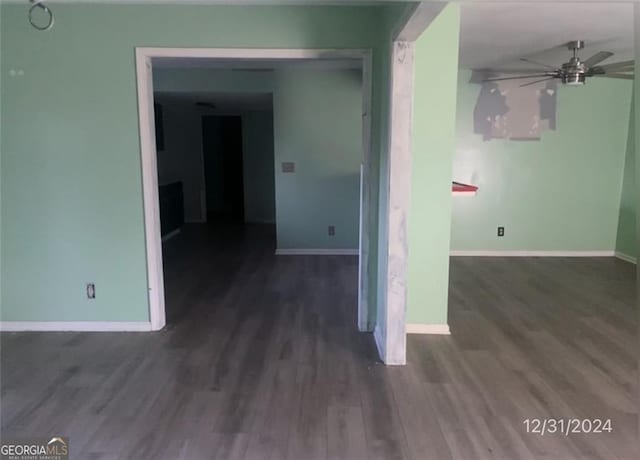 spare room with a ceiling fan, baseboards, and wood finished floors