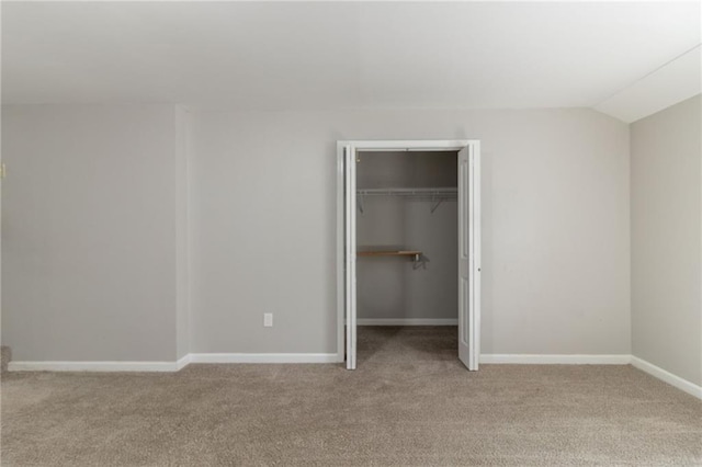 unfurnished bedroom featuring baseboards, light carpet, and a closet